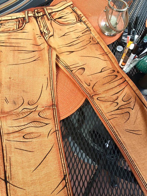 a pair of jeans is cut out and placed on a table