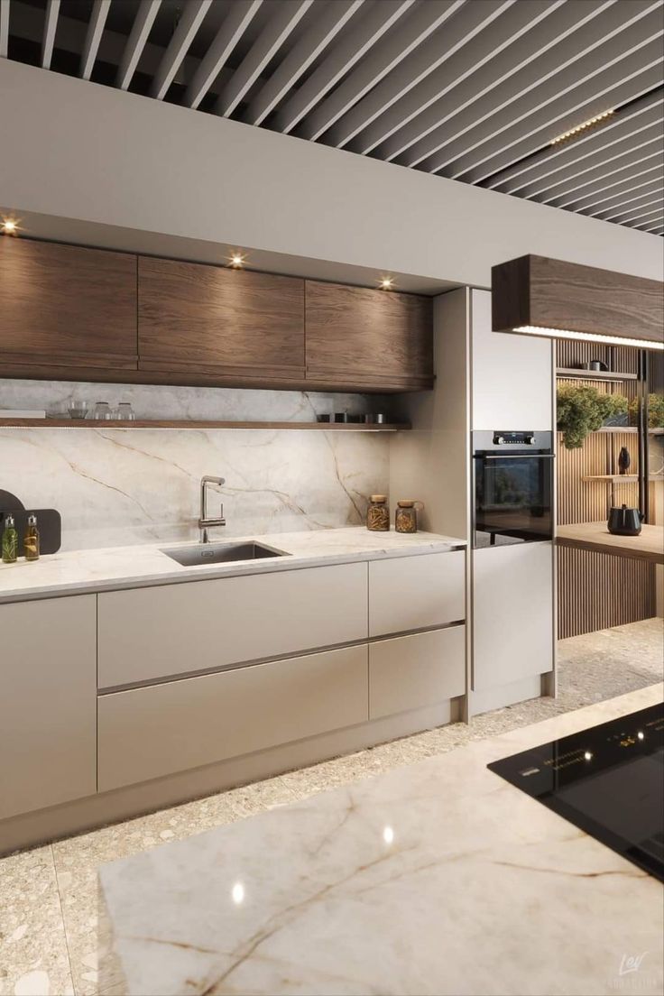 a modern kitchen with marble counter tops and wooden cabinetry, along with stainless steel appliances