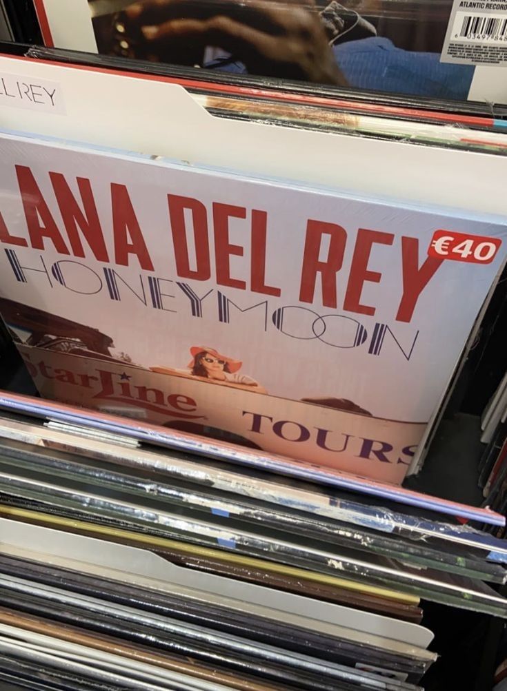 a stack of records sitting on top of a shelf