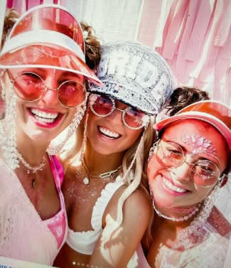 three women with their faces covered in pink and white powder are posing for the camera