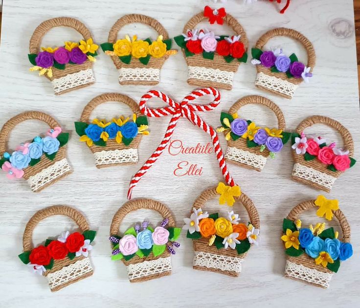 a bunch of small baskets with flowers on them sitting on a table next to some candy canes