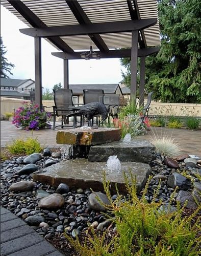 an outdoor patio with rocks and water features