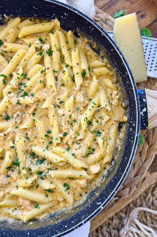 a pan filled with pasta and cheese on top of a table