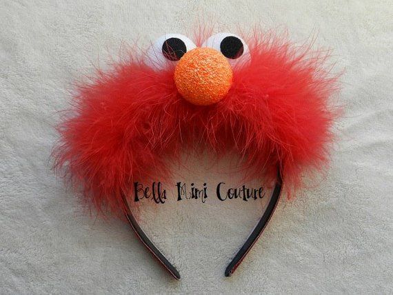 a red furry animal headband with black eyes