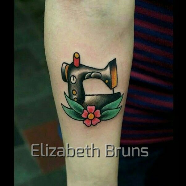 a tattoo with a sewing machine on it