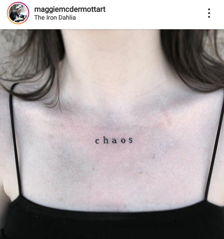 a woman's chest with the word chaos tattooed on her left side ribcage