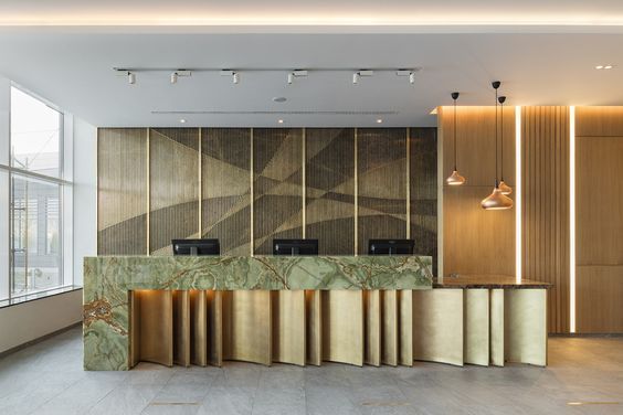 an empty lobby with marble counter tops and lights