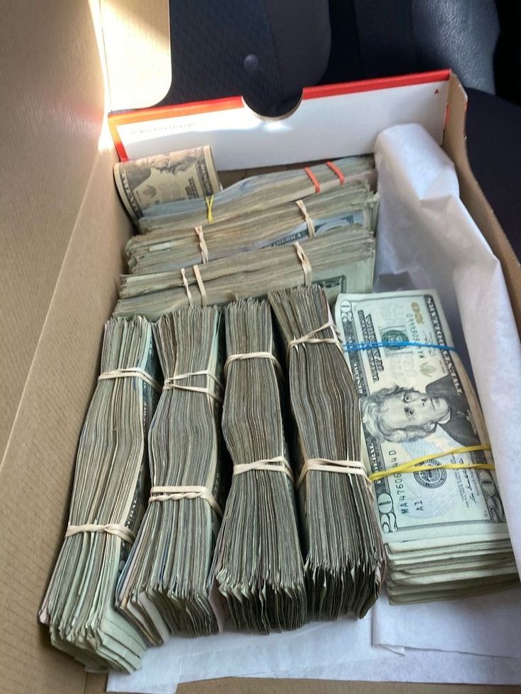 a box filled with lots of money sitting on top of a table