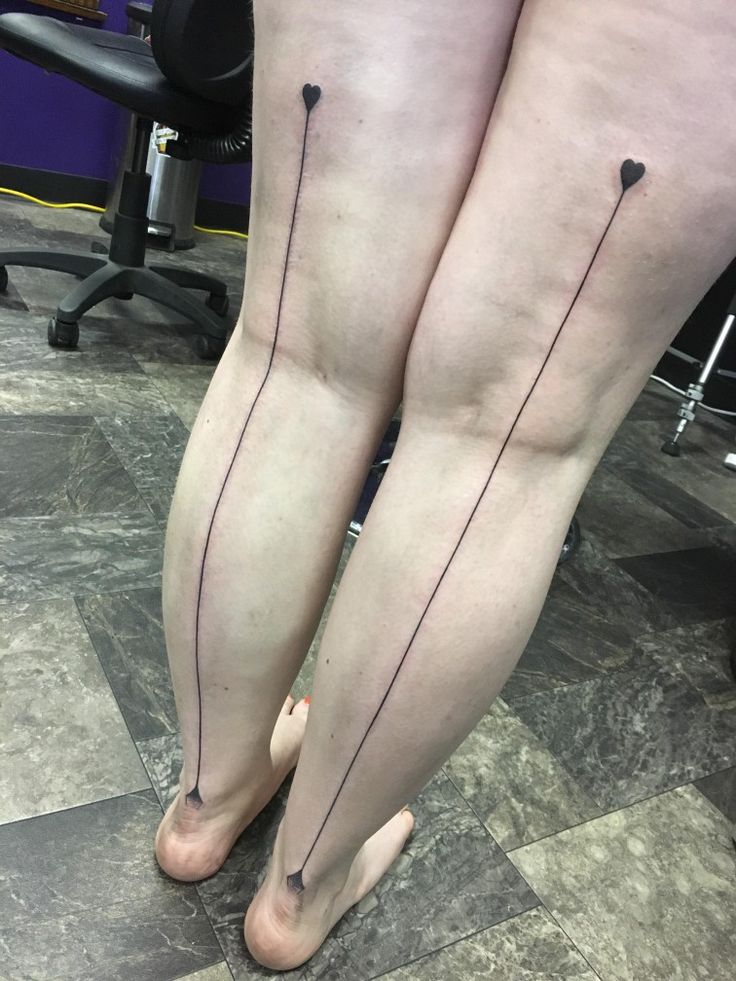 two women's legs with black lines on them