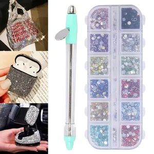 the case is filled with lots of different types of jewel stones and a pen in it