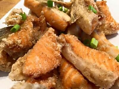 fried fish and vegetables on a white plate