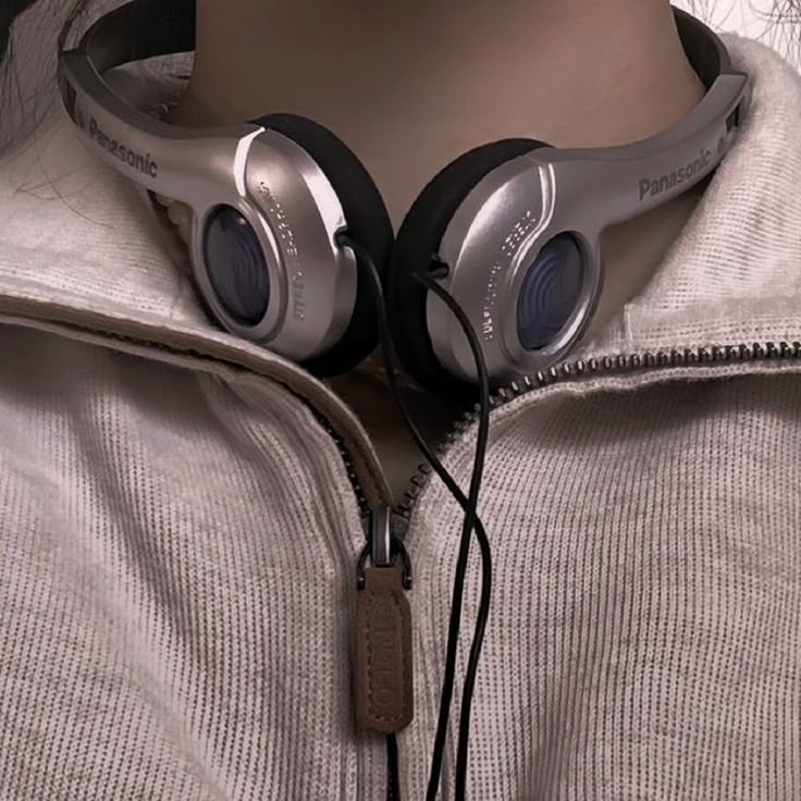 a close up of a person wearing headphones on top of a mannequin