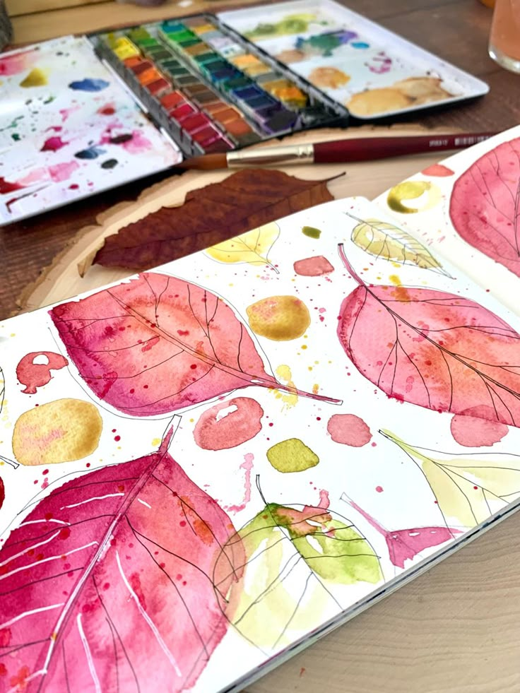 watercolors are being used to create an art project with leaves and acrylic paint