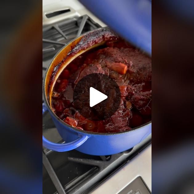 a blue pot filled with food sitting on top of a burner oven next to an oven