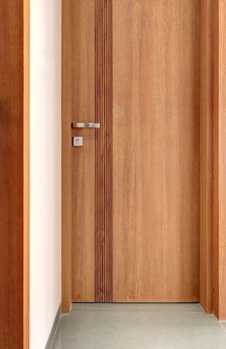 a wooden door with a metal handle on the front and side doors to both sides