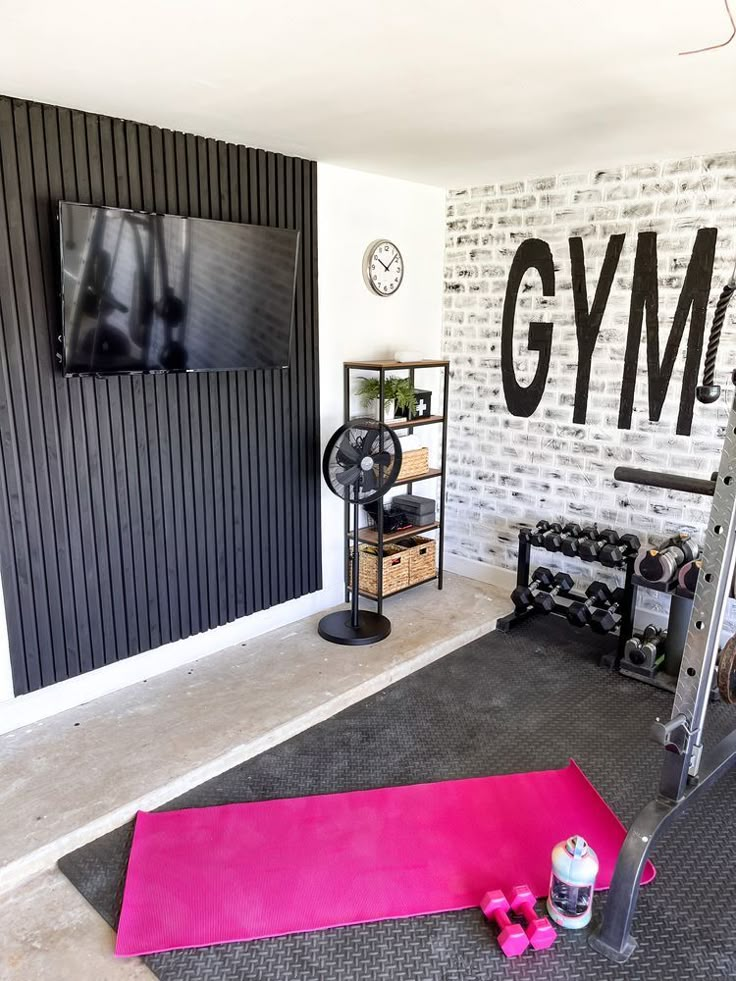 there is a gym room with pink mats on the floor