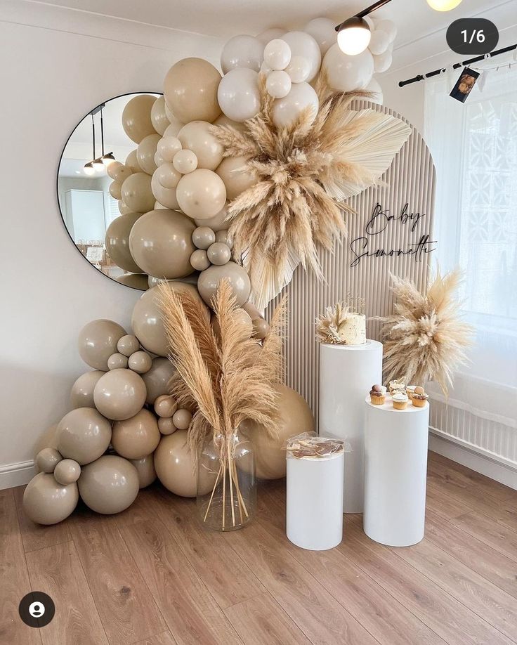 balloons and decorations are arranged on the floor in front of a wall with a mirror