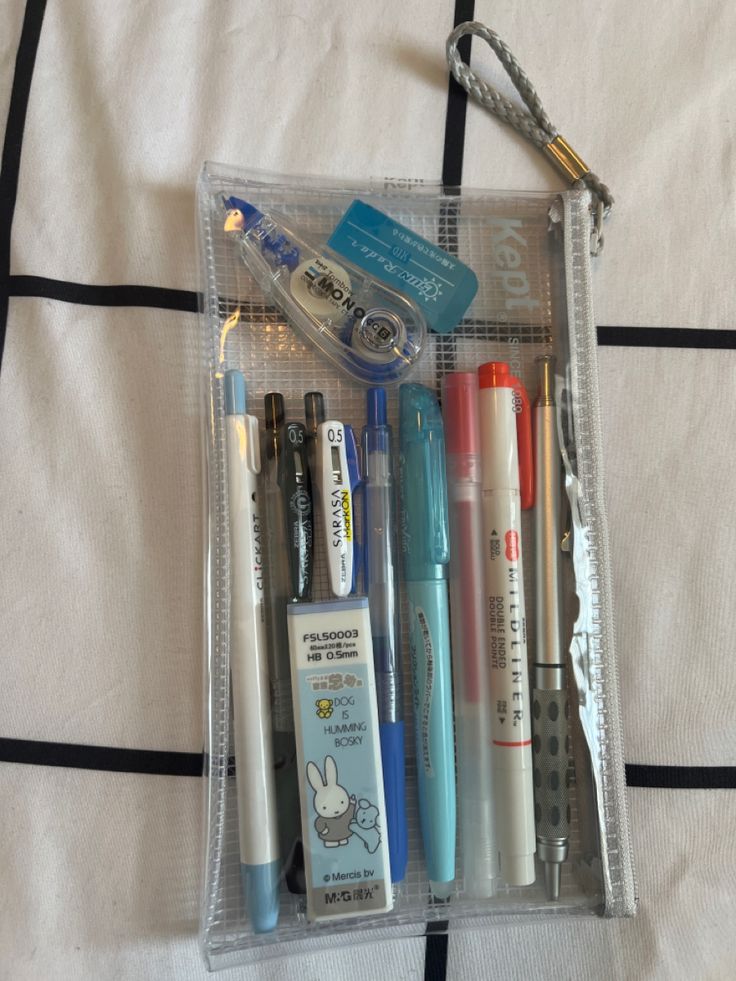 several pens and markers are in a clear case