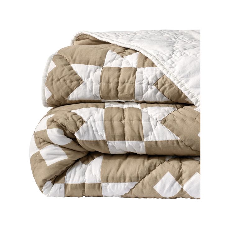 two blankets are folded on top of each other, one is brown and the other is white