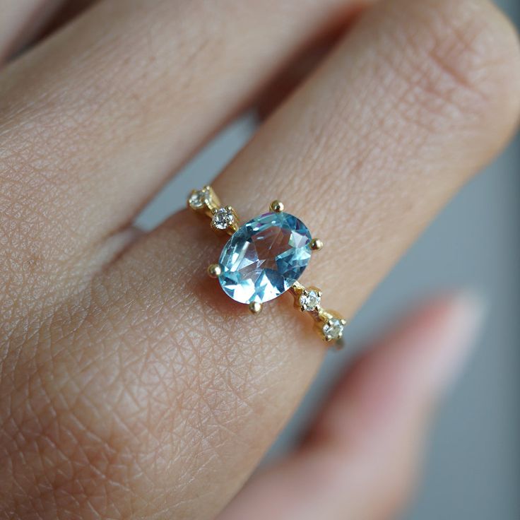 Picture a summer blue sky with the smell of fresh flowers in the air. This blue topaz ring reminds us of just that. Available in yellow gold, rose gold and silver, or 14K solid gold. Gold vermeil or 14K solid gold Natural 8x6mm Blue Topaz 1.2mm shank thickness Round CZs (what's this?) ** This item is specially made for you. Please allow 1-2 week lead time. ShippingDomestic: Free standard shipping within the U.S.International: Free standard shipping for orders over $200 Custom SizesNot sure what Senior Ring, Dreamy Rings, Blue Topaz Ring Gold, Senior Rings, Sparkly Rings, Topaz Wedding Ring, Sky Blue Topaz Ring, Blue Topaz Engagement Ring, Fall Rings