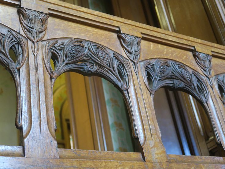 an ornate wooden window frame with carved details