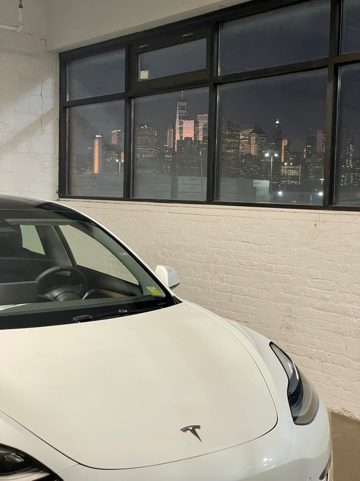 a white car parked in front of a window