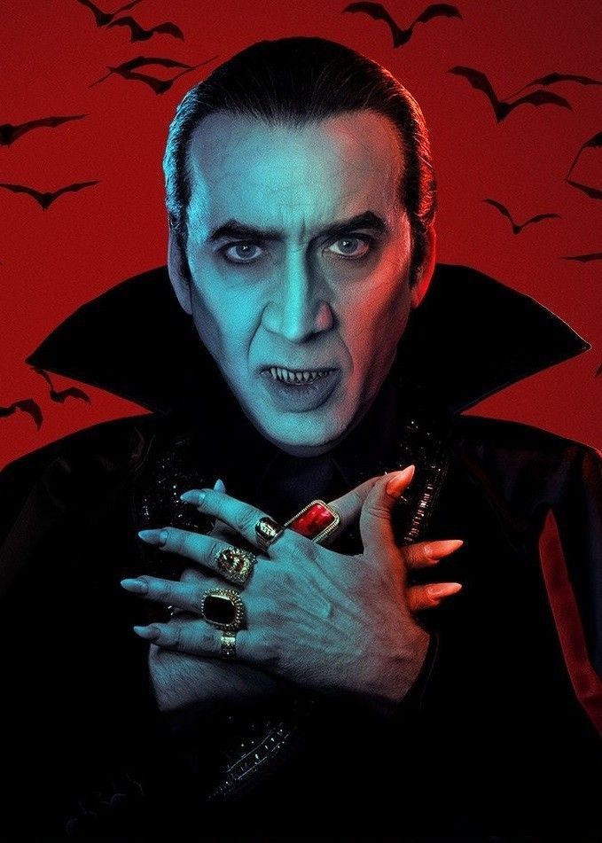 a man dressed as dracula with his hands on his chest and birds in the background