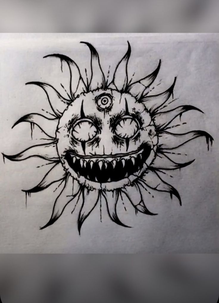 a drawing of a smiling sun with big eyes and sharp fangs on it's face