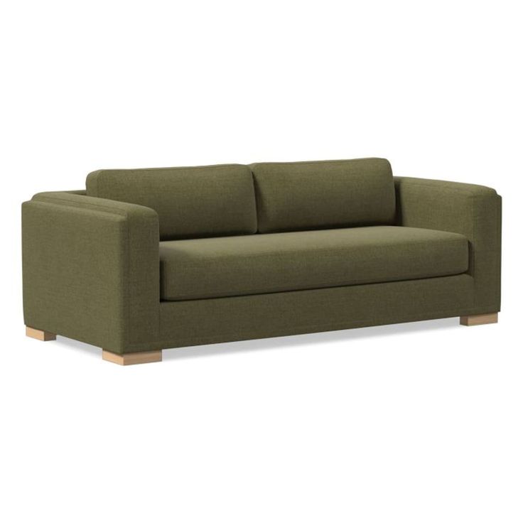 a green couch sitting on top of a white floor