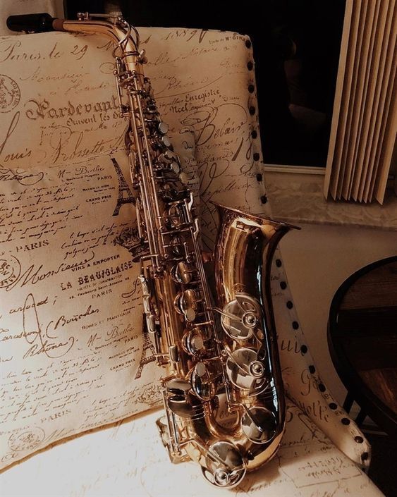 a saxophone sitting on top of an old piece of paper