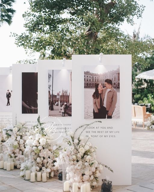 an outdoor ceremony with white flowers and candles on the ground, surrounded by cards that say i do not know what they are