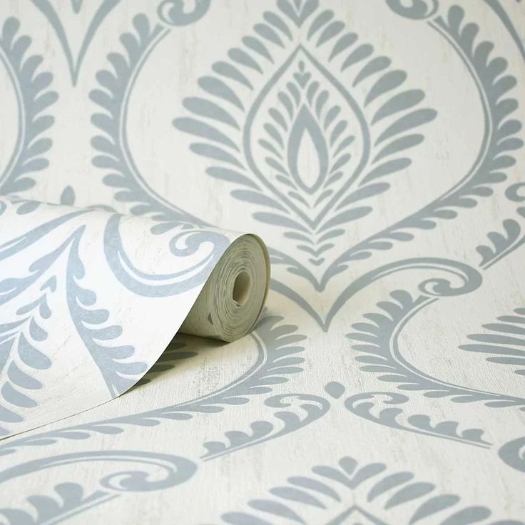 a roll of wallpaper with an ornate design on it