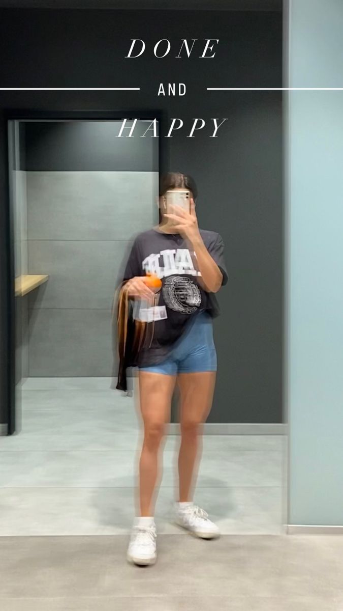 a woman standing in front of a door talking on her cell phone