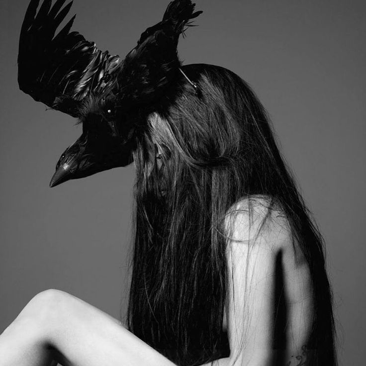 a woman with long hair and a bird on her head