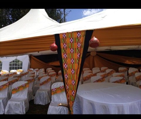 tables and chairs are set up under a tent