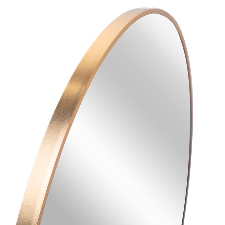 an oval mirror with gold trim around the edges on a white background is shown in this image