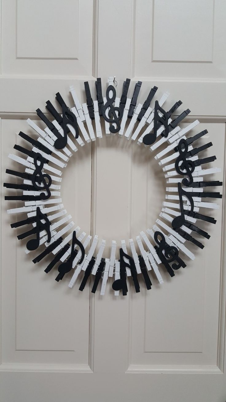 a wreath made out of black and white matchesticks with the word happy birthday written on it