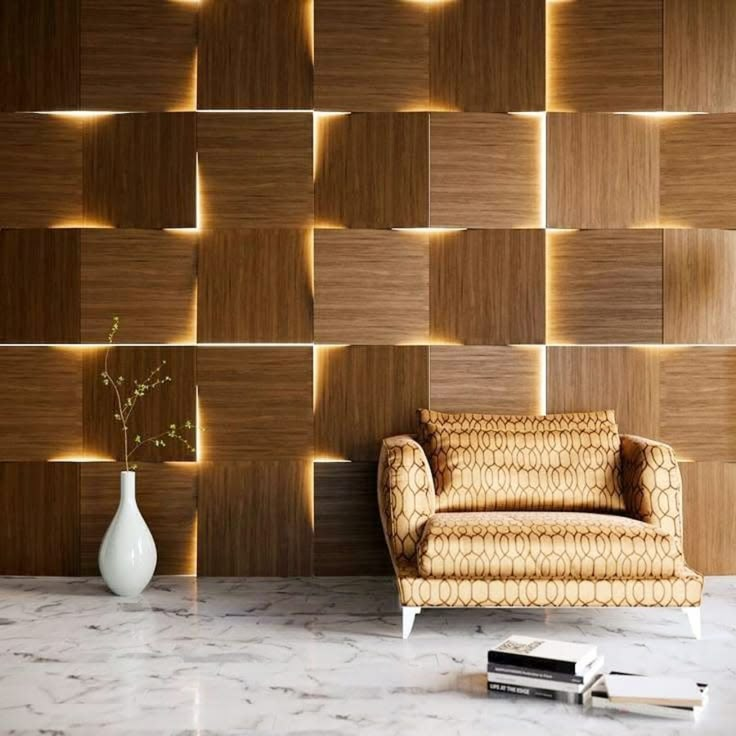 a chair sitting in front of a wall with lights on it and a vase next to it