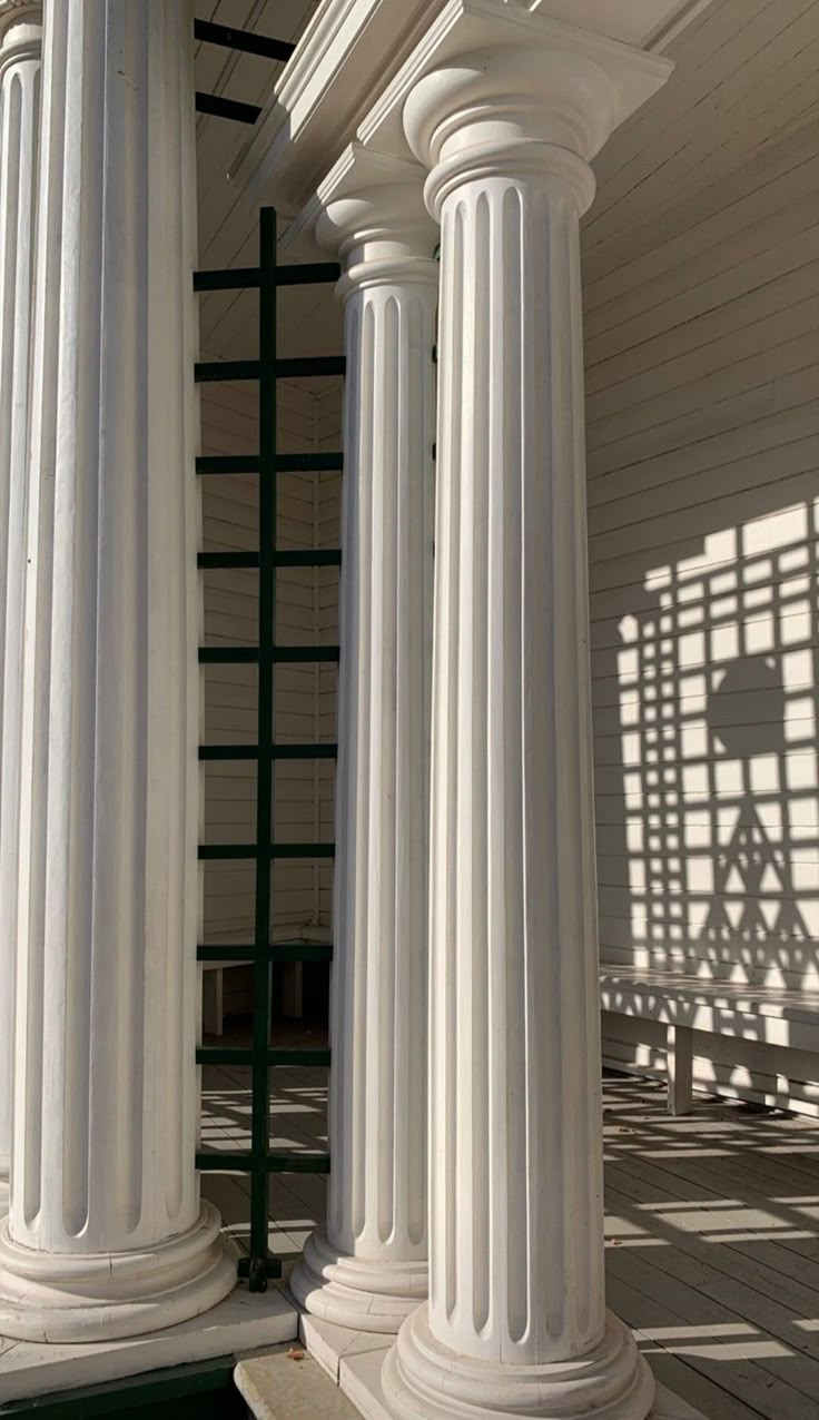 two white pillars on the side of a building