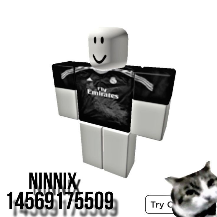 a cat is looking at a paper man with a shirt on it's chest