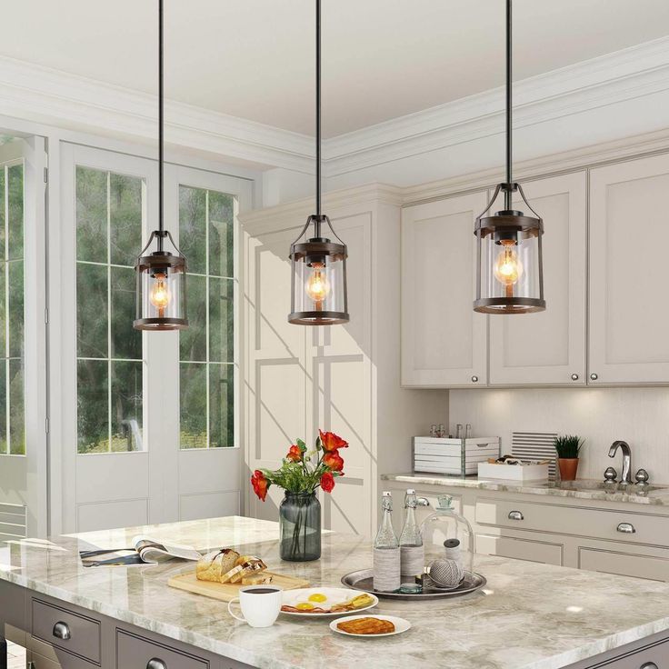 Well design by LNC lighting, the Laius collection features a wood accent tone cylindrical silhouette and slender adjustable down robs in a versatile solid finish, centered by a clear glass shade completes its charming modern flair. This timeless mini kitchen island pendant lighting with impressive cylindrical clean-lined frame wood tone finish, brings a hint of farmhouse influence as it illuminates any of your room like kitchen island, entryway, living room, dining rooms, foyer and corridor. LNC Glass Island Pendant Lights, Glass Kitchen Island, Black Modern Farmhouse, Lights Over Island, Kitchen Island Pendant Light, Lights Over Kitchen Island, Farmhouse Kitchen Island, Kitchen Island Pendant, Rustic Pendant Lighting