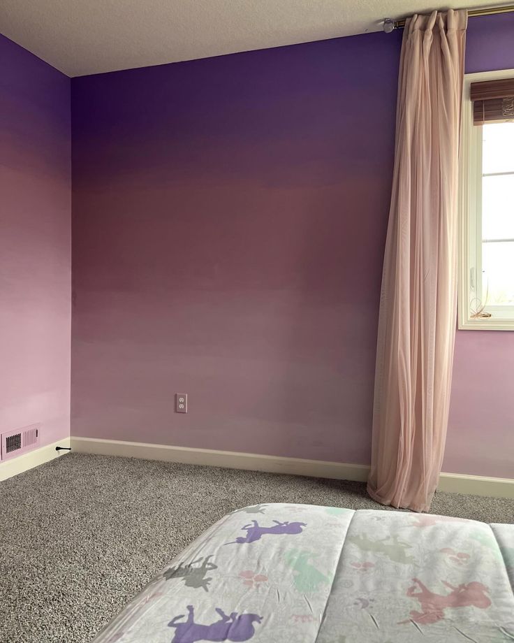 a bedroom with purple walls and carpeted flooring