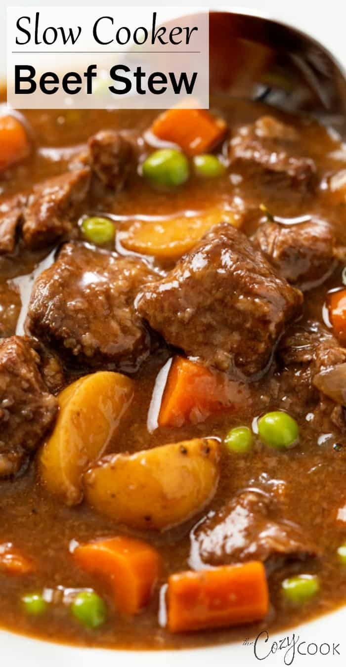 beef stew with carrots, potatoes and peas in a slow cooker on a white plate