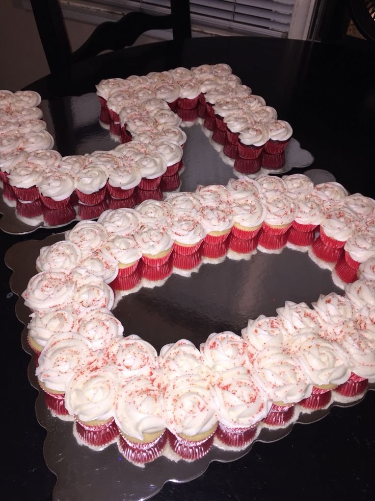 two heart shaped cupcakes sitting on top of a table