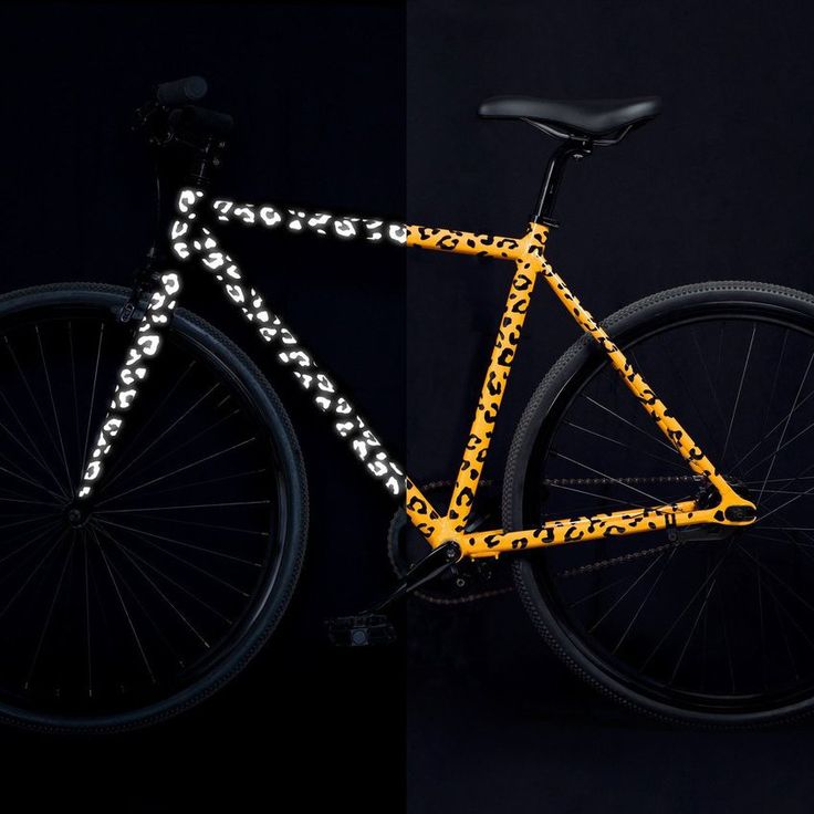 a yellow bicycle with black and white designs on it's front wheel, and the words free transport written across the frame