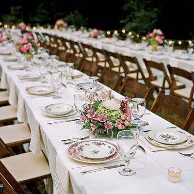 a long table is set with plates and silverware