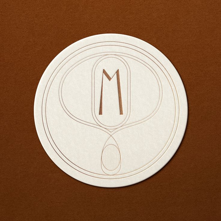 a white circular sticker with the letter m on it