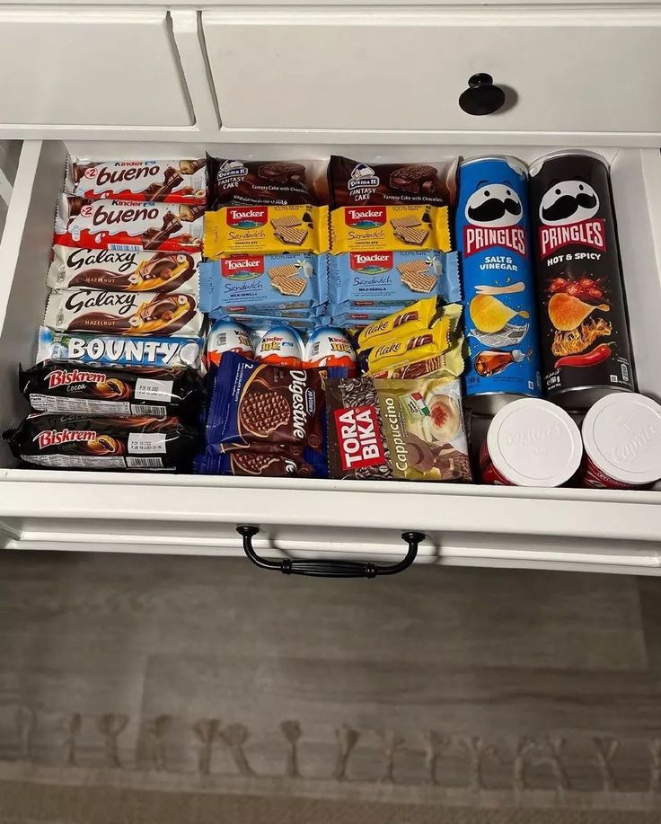 an organized pantry drawer filled with snacks and condiments