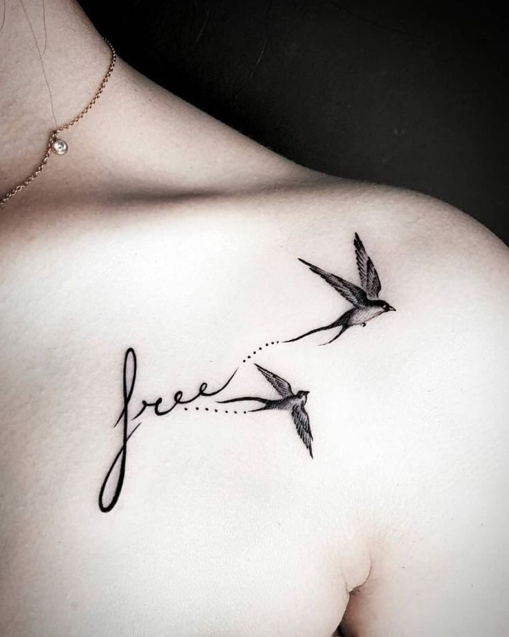 the back of a woman's shoulder with two birds on it that say free