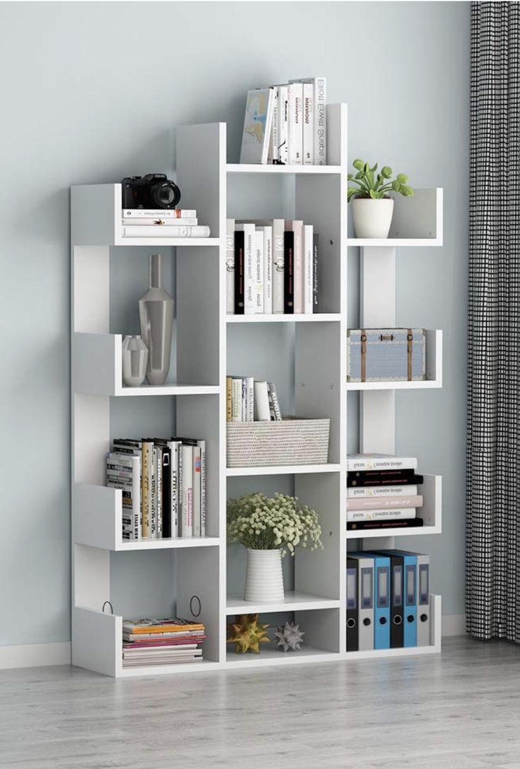 a white book shelf with books and other items on it